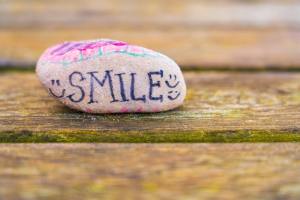 Rock painted with the word Smile